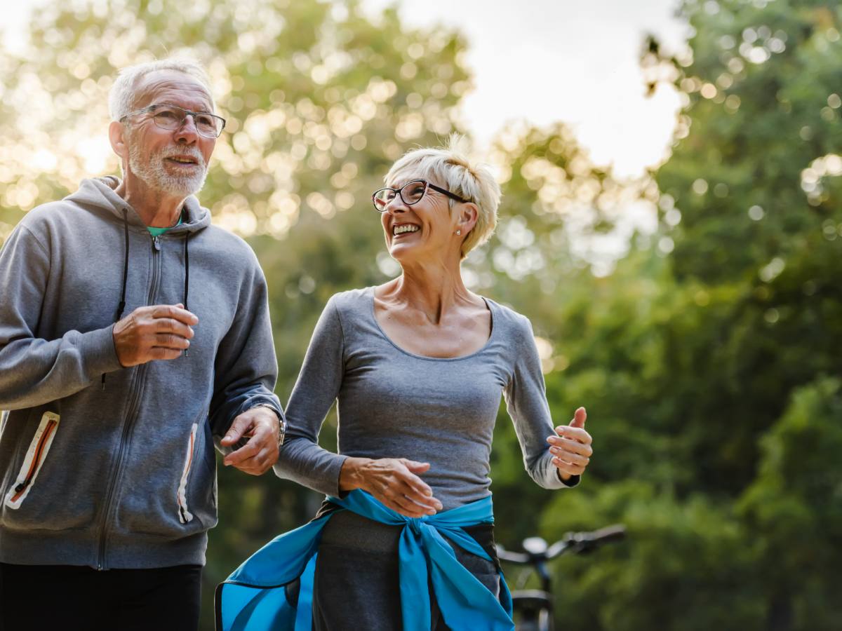 MindSpan Program — older couple jogging together outdoors at golden hour, smiling and active